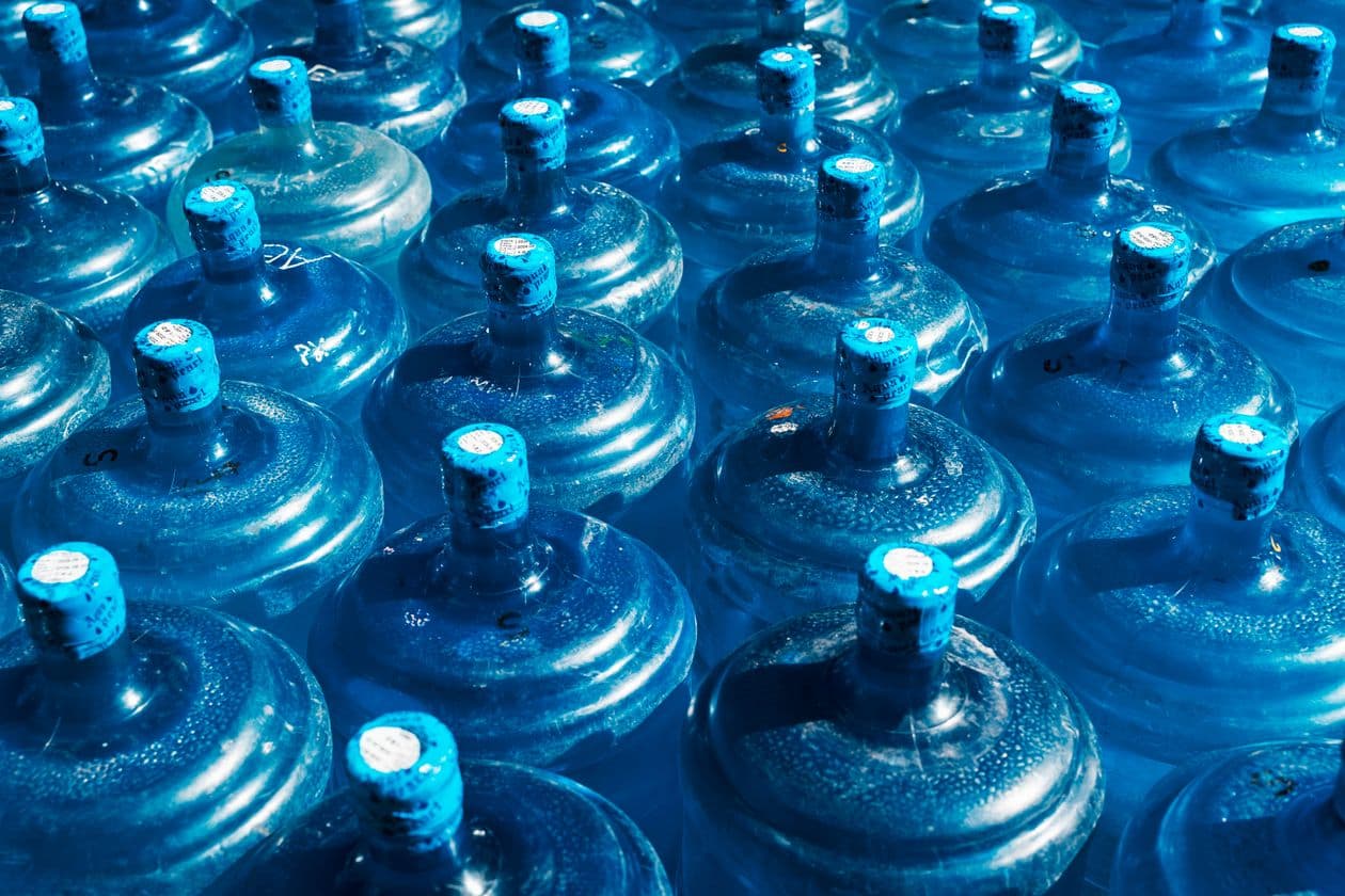 Rows of sealed 20L water jars ready for delivery